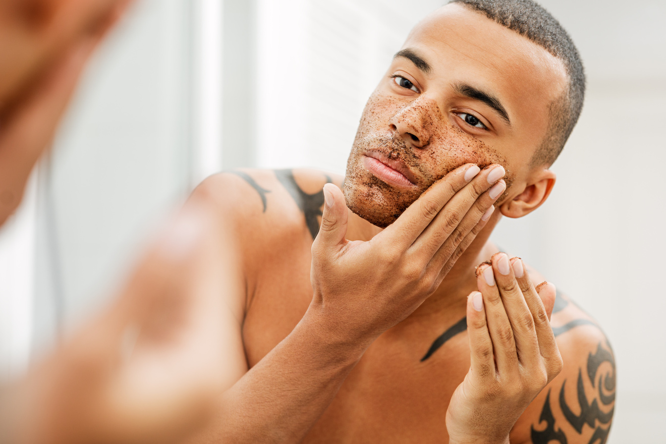 Handsome Young Man Putting Facial Scrub