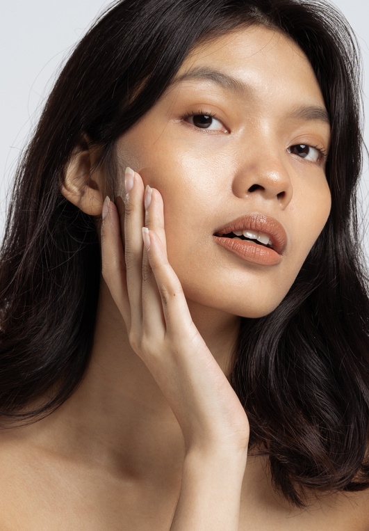 Closeup Portrait of a Woman Touching Her Face