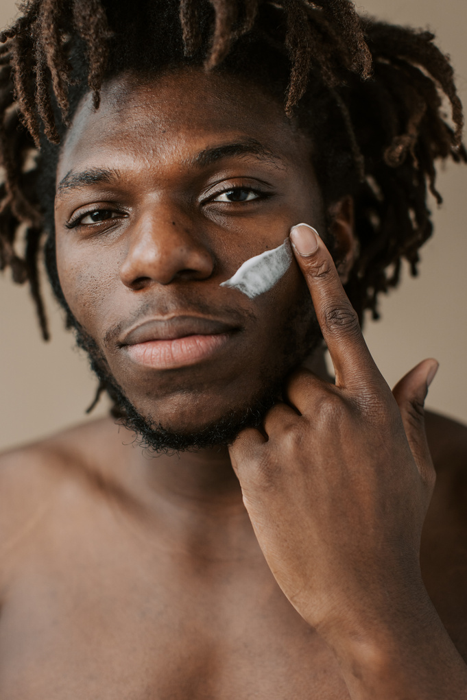 Man Applying  Cream on Face